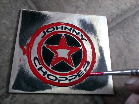 Hand colouring the Johnny Chopper badge prototype